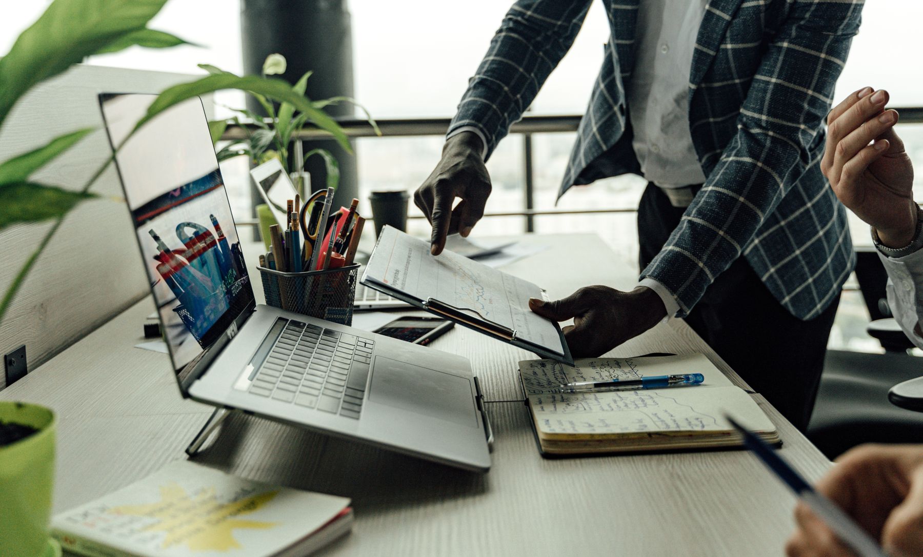 financial analysts reviewing market reports on a laptop