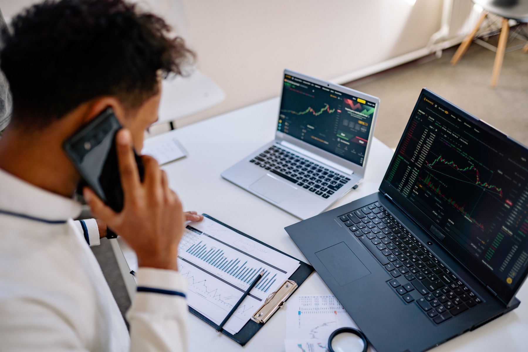 Equity research with financial charts and multiple screens